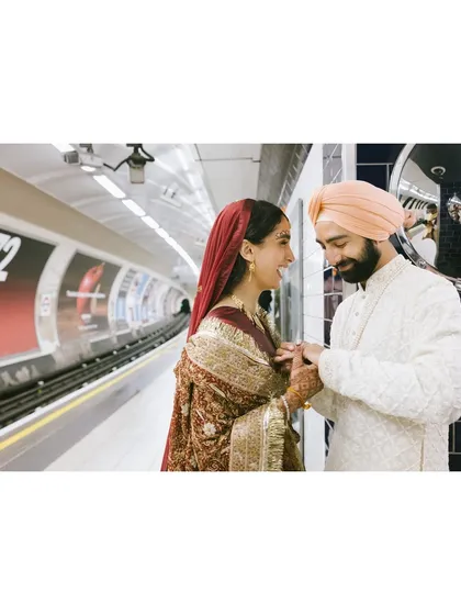 A candid moment of laughter between Shaan and Shubham as they wait for the train in a London tube station. Their joy is palpable, even in the midst of a bustling city.