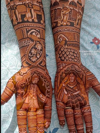 A high-quality image of the classic Dulha-Dulhan portrait design, framed by arches and complemented by elephant processions on the forearms.