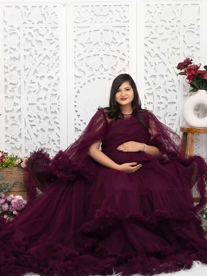 Feel like royalty in one of my lavish gowns. This portrait was taken in my Jaipur studio, using an elaborate floral set to create a rich, luxurious atmosphere for this special memory.