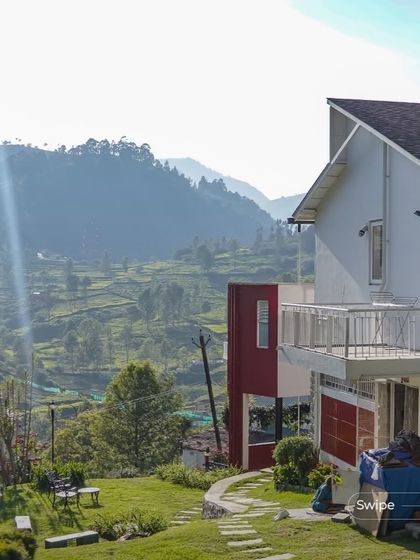 A duplicate of 143, this image shows the farmhouse's exterior against the backdrop of the misty hills, emphasizing its picturesque setting.