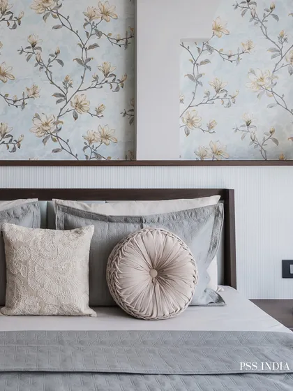 A touch of romance with a delicate floral wallpaper. Paired with soft grey bedding and textured round cushions, this design creates a serene and pretty bedroom that feels both classic and fresh.