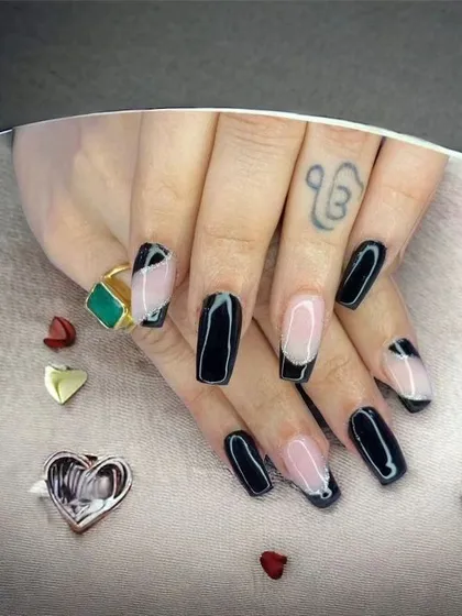 A modern take on a French manicure with black squared-off tips on a nude base.