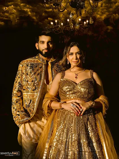 A classic, elegant portrait. They stand together, exuding grace and confidence in their magnificent golden outfits. A timeless shot from their magazine-style session.