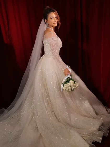 A final look back. The soft, romantic makeup and elegant gown create a truly memorable bridal moment.
