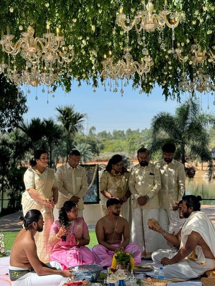 Family members gather for the rituals at this outdoor engagement. The decor was designed to feel luxurious yet integrated with the natural lakeside setting.