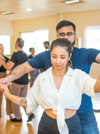 A beautiful moment of partner work instruction. Learning to lead and follow with grace and precision is a key focus in these workshops.