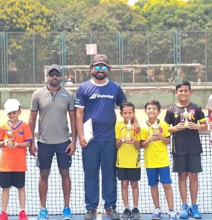 Our junior and senior players posing with their trophies and coaches after a great performance.