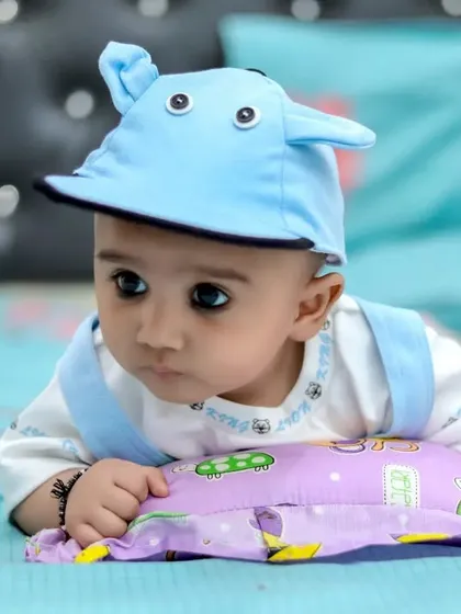 A thoughtful-looking baby during an indoor photoshoot. We take the time to capture a range of expressions, from joyful to contemplative.