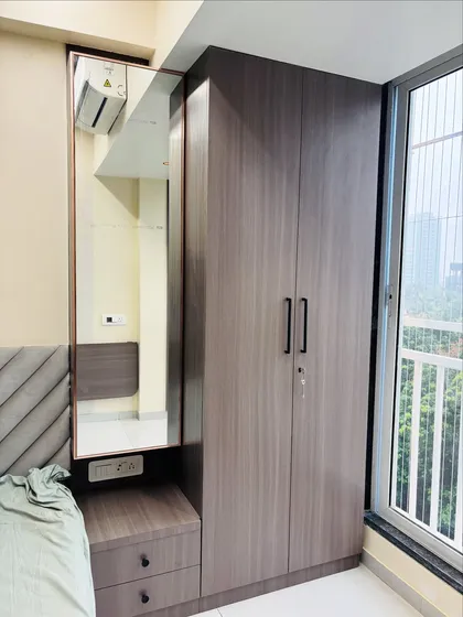 A compact wardrobe and dressing table combination in a wood-grain laminate. This is a perfect all-in-one solution for smaller bedrooms.