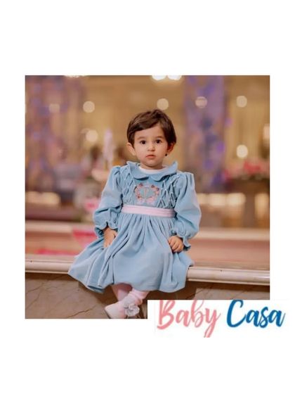 A quiet moment of elegance. This little girl is wearing our vintage-inspired dusty blue velvet dress, a perfect and comfortable choice for a formal event or a winter birthday party.