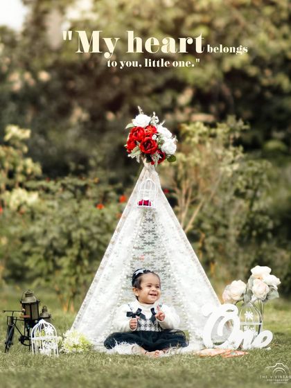 A sweet and stylish first birthday portrait in an outdoor teepee setup. We use props and styling to create a cohesive and beautiful theme for your child's photos.