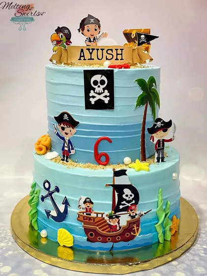 Ahoy, matey! This pirate-themed two-tier cake is ready for a treasure hunt. Decorated with a pirate ship, treasure map, and cute pirate characters, it's perfect for an adventurous birthday boy.