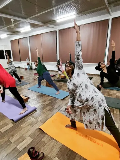 A glimpse into our group class practicing Trikonasana. I ensure everyone, regardless of their level, learns the correct posture to get the full benefits of each asana in a safe and supportive environment.