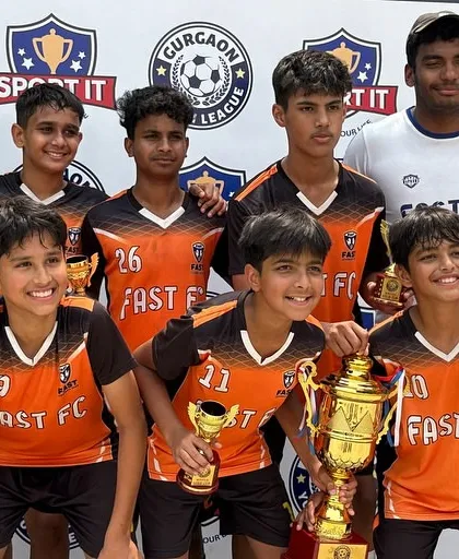 The victorious U13 Blue team, winners of the Gurgaon Youth League. Each player holds their well-earned trophy, marking a successful campaign built on teamwork and skill.