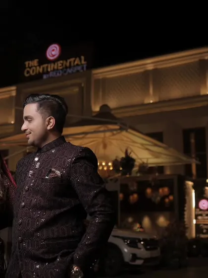 A beautiful nighttime shot of Saurabh and Komal outside their reception venue, The Continental. We use ambient lighting to create a romantic and grand portrait.