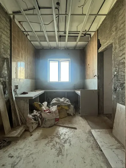 A before-and-after shot of the kitchen, showing the transformation from a raw construction space to a finished, modern culinary hub.