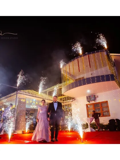 A grand entrance! Our bride and groom arrive at their reception, with her custom rose gold gown sparkling under the lights.