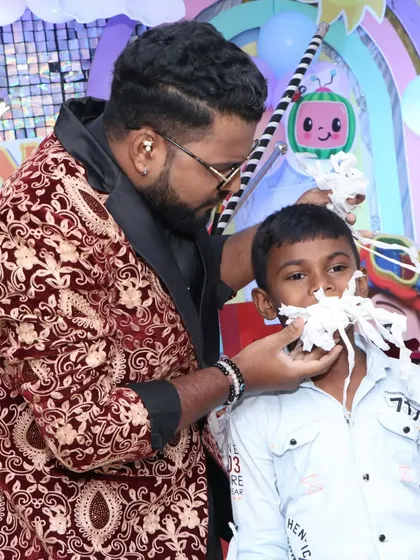 This young volunteer is about to experience one of my funniest and messiest tricks. It's moments like these that create huge laughs and make a birthday party unforgettable.