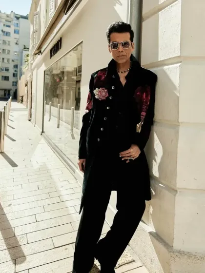 A full-length view of the bespoke Indowestern floral jacket worn by Karan Johar. The elongated silhouette and striking embroidery make it a powerful statement piece for any major event.