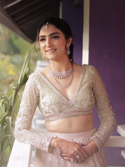 A beautiful portrait of the bride, looking serene and elegant. Her hair is styled in a soft updo that complements her delicate features.