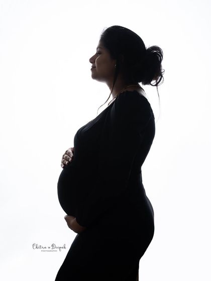 A classic maternity silhouette. This pose is all about celebrating the beautiful curve of the baby bump in a simple, artistic way.