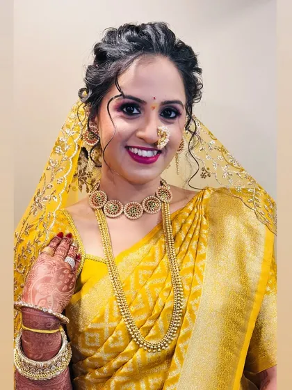 A close-up of her happy face, with makeup that highlights her smile.