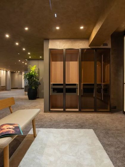 Additional views of the Gala showroom, showcasing the luxurious walk-in closet displays, the reflective marble floor, and the seamless integration of product showcases into the architectural design.