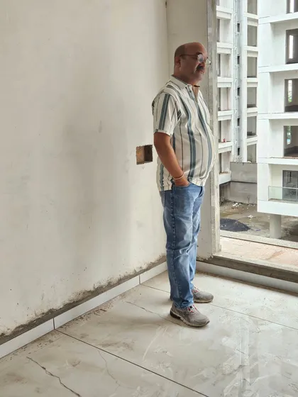 Taking a moment to assess the view and energy from a large window in a high-rise apartment. The external environment significantly influences the internal Vastu.