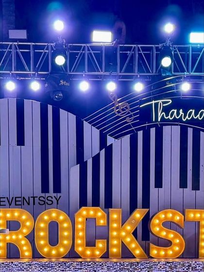 A close-up of the "ROCKSTAR" marquee letters on the main stage. The bright lights and bold lettering are essential elements for creating an authentic concert feel for this music-themed birthday.