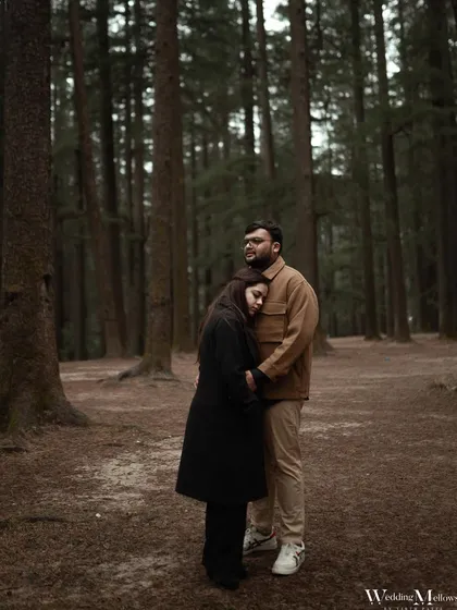 Finding comfort in each other's arms in the quiet woods of Manali. This photo captures a feeling of safety and intimacy, with the tall pine trees creating a sense of seclusion.
