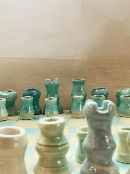 A close-up of the unique, hand-sculpted chess pieces, each with its own personality.