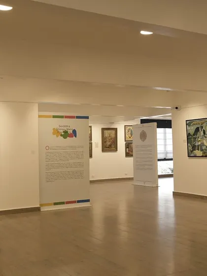 A wide shot of the gallery space during a Curator's Walk, inviting visitors to explore two floors of artistic brilliance at 'The Masters & The Modern.'