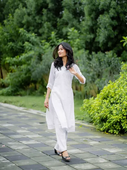 A candid walking shot that feels natural and unposed. The movement in her hair and the easy stride make this a great lifestyle image.