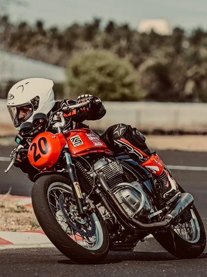 A rider on a Royal Enfield GT 650, demonstrating excellent cornering form.