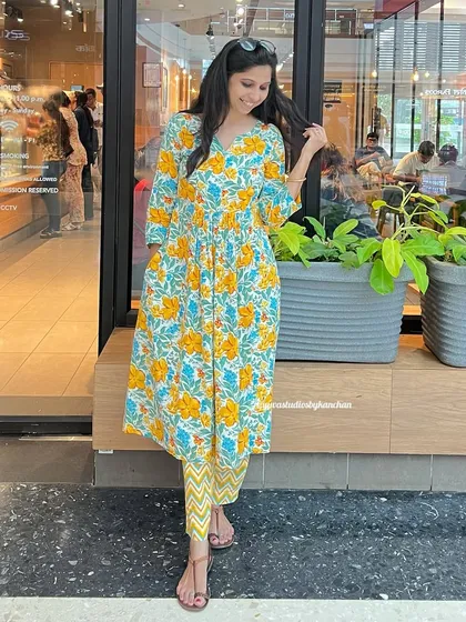 A closer look at the yellow floral kurta-pant set. The vibrant print and comfortable cotton make it a perfect choice for festive days.