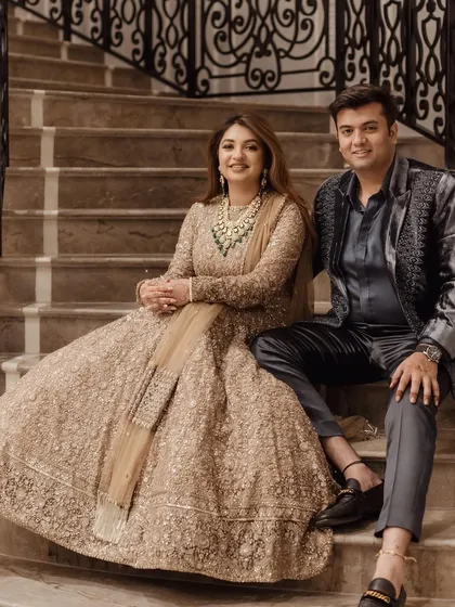 A sweet moment on the stairs. Madhushree's reception makeup was designed to be photogenic from every angle, ensuring she looked perfect in all her wedding portraits.