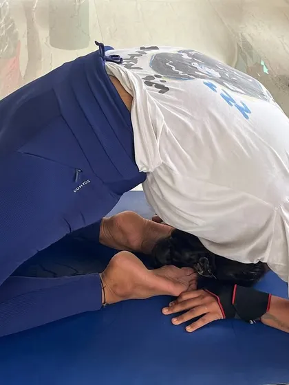 A male practitioner holding Kapotasana, demonstrating the strength and flexibility developed through a dedicated Ashtanga practice.