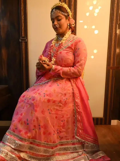 A full-length view of my Radha costume, complete with floral jewelry, showcasing the attention to detail in my themed appearances.