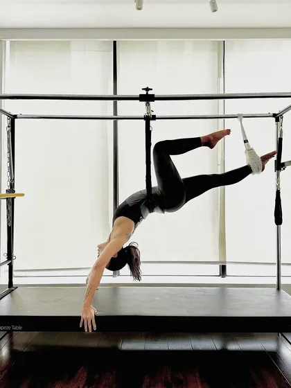 A hanging stretch on the Cadillac. This type of inversion is excellent for decompressing the spine and improving circulation.