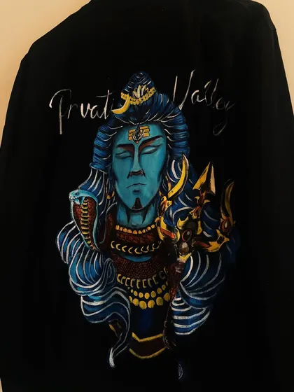 A slightly different angle of the finished Shiva jacket, highlighting the metallic sheen in the script and the deep, meditative expression on Shiva's face.