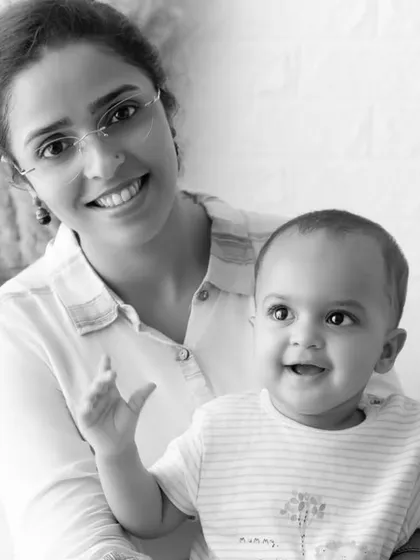 A classic black and white portrait of a mother and her happy baby. This timeless style emphasizes emotion and connection, creating a portrait that will never go out of style.