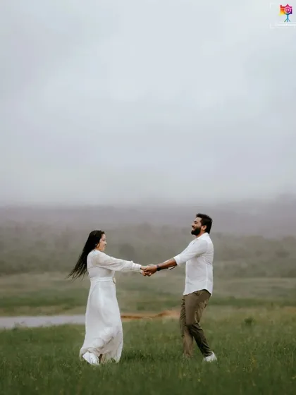 A candid shot of a couple dancing in a misty field, their joy and movement creating a beautiful, spontaneous portrait.