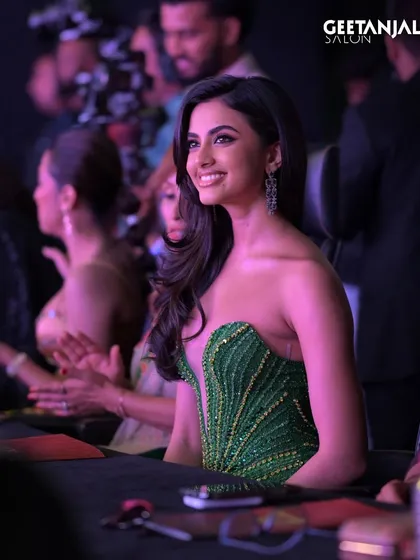 A candid shot of Rhea Singha enjoying the Miss Universe India event. Her makeup remains flawless even off-stage, highlighting the longevity and quality of our work.