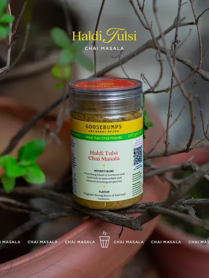 My Haldi Tulsi Chai Masala jar resting near a tulsi plant, the source of its refreshing flavour. This blend combines the wellness properties of turmeric and holy basil for a rejuvenating tea experience.
