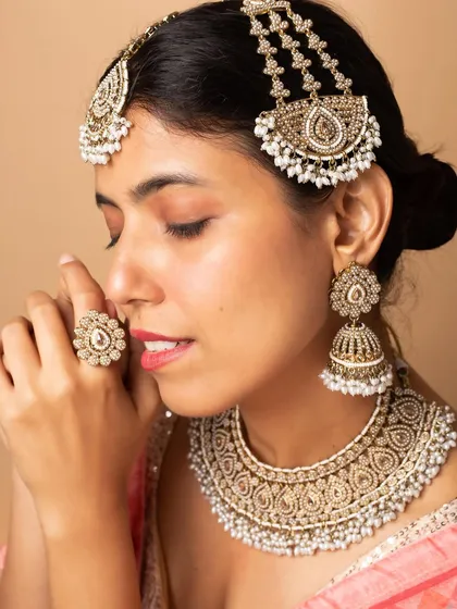Modeling for bridal jewellery requires attention to detail and the ability to convey emotion. This close-up shot highlights an intricate kundan and pearl bridal set, perfect for wedding campaigns and catalogues.