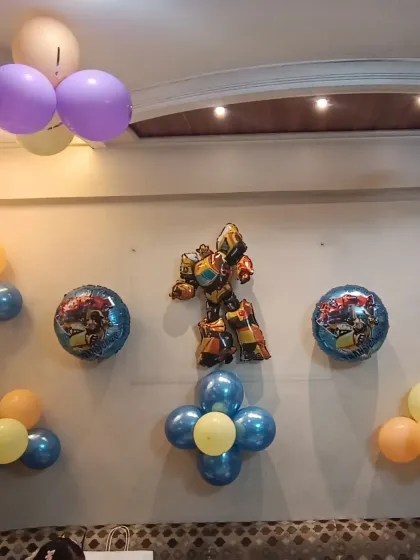 Themed foil balloons, like this Transformer, can be added to complement a broader space or robot theme, adding more fun elements for the kids.