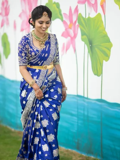 A duplicate of image 104, showing the bride in her stunning royal blue Banarasi saree and custom silver-embroidered blouse.