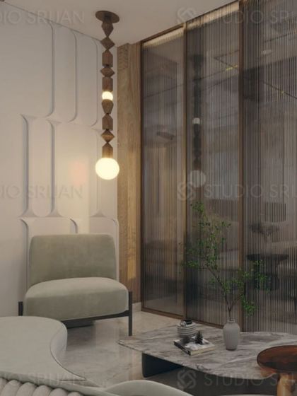 A cozy corner in the Patel Nagar bedroom, featuring a modern armchair and a unique, sculptural pendant light.