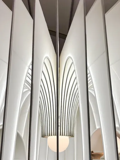 A closer look at the heart of our fabric sanctuary. We designed the central light fixture to complement the gracefully arching fins of the structure. This detail shows our commitment to making every element, from the grand architecture to the delicate lighting, part of a single, cohesive story.