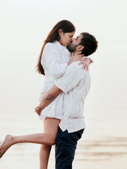 A classic romantic lift against the bright sky. This is a timeless pre-wedding pose that is always full of joy and emotion.